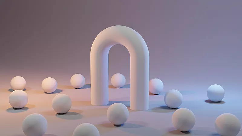 Een witte boog gemaakt van een ronde buis. Op de grond rondom de boog liggen 14 witte ballen van dezelfde grootte verspreid.