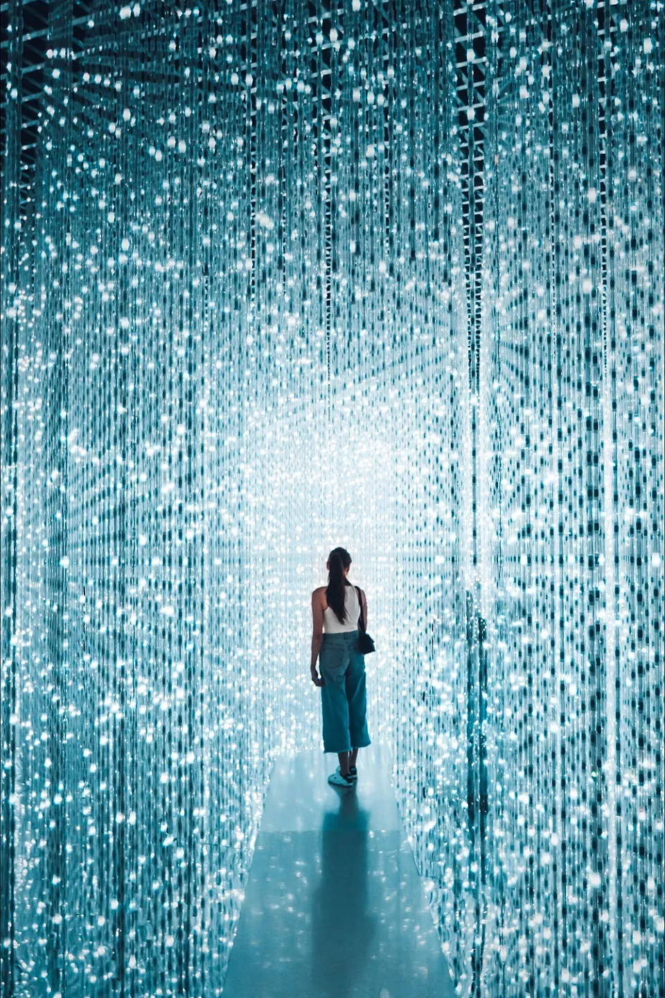 Person is standing in the middle of a room with blue lights